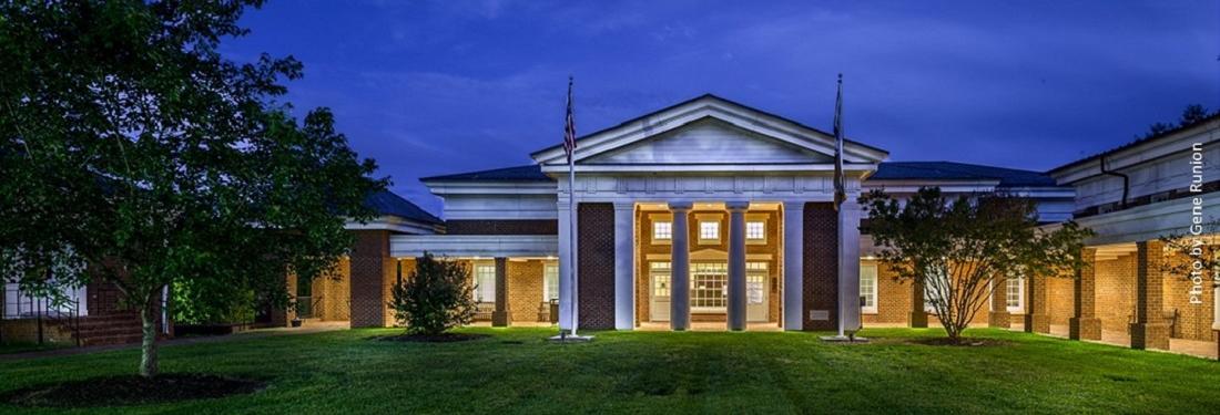 dark skies over a brick building that is illuminated with lights