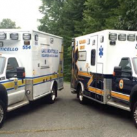 Two ambulances parked in a parking lot