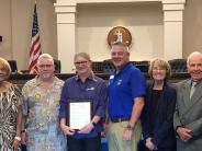 image of Catherine Garcia receiving the community service award from the Board of Supervisors