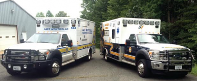 Two ambulances parked in a parking lot