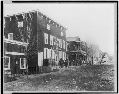 a street scene from the early 1900s with many buildings along a main street